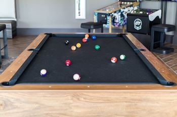 Open air game room with golden tee golf video game, billiards, and much more